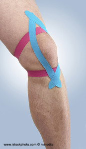 Therapeutic treatment of knee with tex tape.